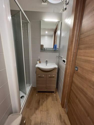a bathroom with a sink and a mirror and a toilet at Casa Nicola Maria in Grottaglie