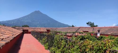 a row of buildings with a mountain in the background at Hotel Eterna Primavera Antigua in Antigua Guatemala