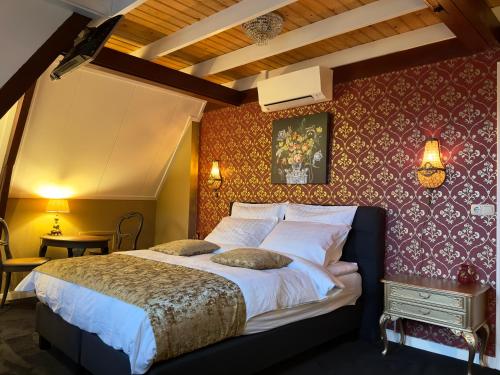 a bedroom with a large bed with a red wall at Villa Giethoorn Steenwyck in Steenwijk