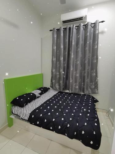 a bedroom with a black and white bed and a curtain at 88 homestay bagan lalang in Sepang