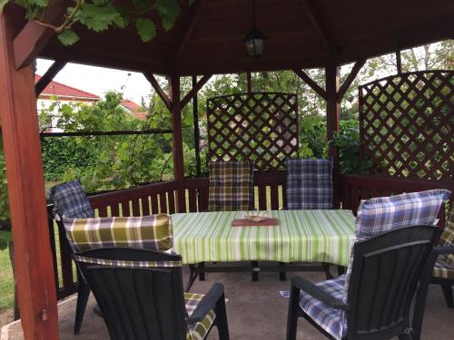 a table and chairs sitting under a gazebo at Katalin vendégház in Sárospatak