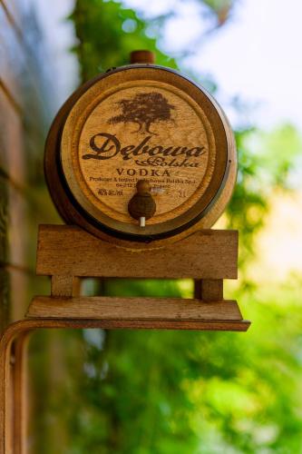 a bottle of wine sitting on top of a wooden table at Willa SPAcja in Wężówka