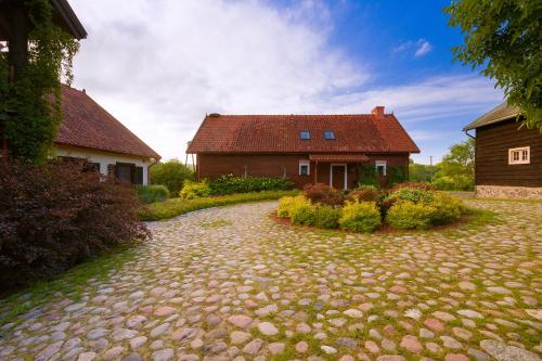 a house with a brick driveway in front of a house at Willa SPAcja in Wężówka