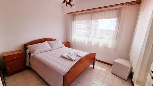 a bedroom with a bed with two towels on it at Apart Hotel Santa Lucia in Mar del Plata