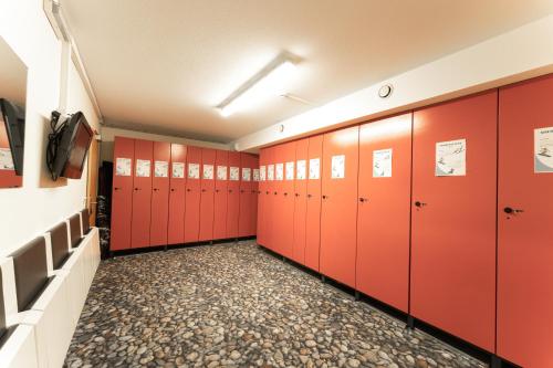 a row of red lockers in a locker room at Aparthotel Dorfplatzl Garni in Tux