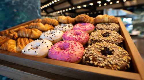 a box of different types of donuts on display at The Flamingo in Timmendorfer Strand