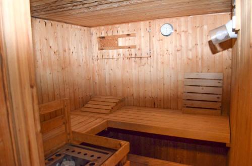 a small wooden sauna with a clock on the wall at Hotel Harzer am Kurpark in Bad Herrenalb