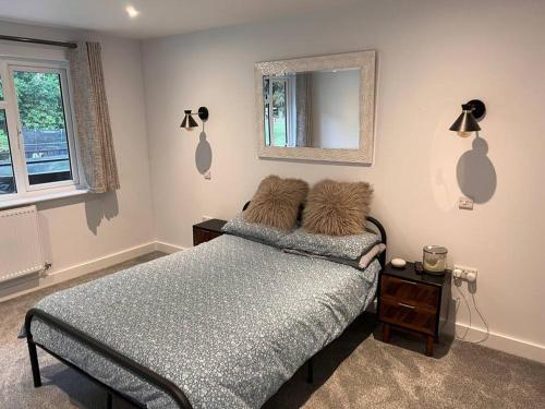 a bedroom with a bed with two pillows on it at Beautiful 5 bedroom home ideal for large groups in Ryde