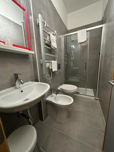 a bathroom with a sink and a toilet and a shower at Hotel Le Calandre in Rubano