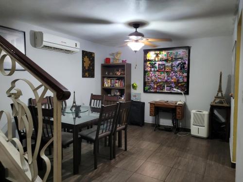 a dining room with a table and chairs in a room at Habitación en casa particular in Monterrey