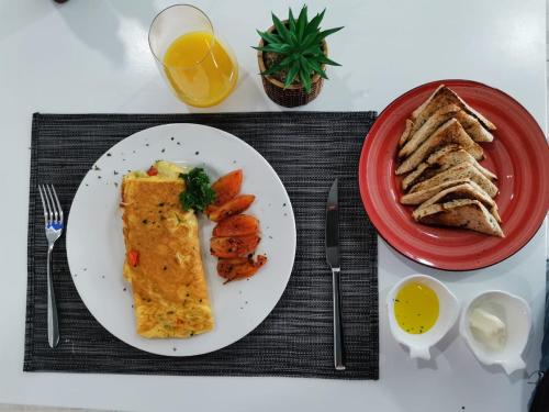 a plate of food with a sandwich and a plate of toast at Plaza Coral Hotel in Punta Cana