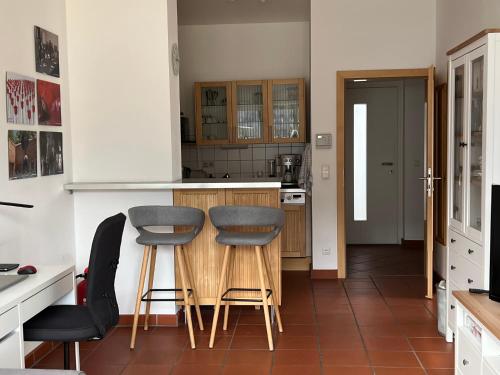 a kitchen with two stools and a counter top at Ferienwohnung Kronegarten in Gmunden