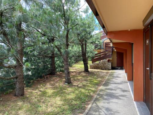 a hallway of a house with trees next to it at Kyriad Direct Roanne Hôtel in Roanne