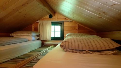 a room with three beds in a attic at 'Monktonmead Lodge' in secluded setting, with private indoor pool. in Ryde