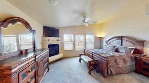 a bedroom with a large bed and a fireplace at Robert's Roost #W4 in Moab