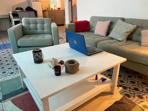a coffee table with a laptop on it in a living room at Relaxing house by the beach - Casa Rosa in Horta