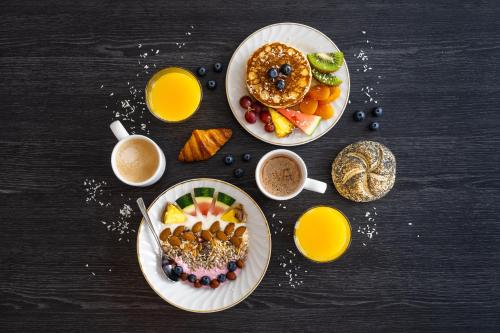 una mesa con dos platos de comida y bebida para el desayuno en The View en Honningsvåg