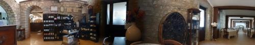 a room with a stone wall and a dining room at Tenuta Chianchito in San Giovanni Rotondo