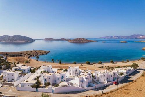 a view of a beach with white buildings and the water at Nefeli Residence @ Astypalaia island in Analipsi