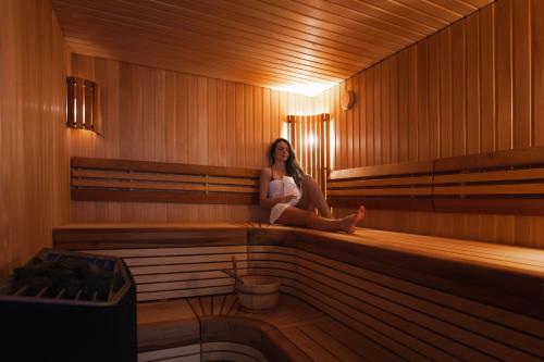 a woman sitting in the inside of a sauna at The View in Honningsvåg