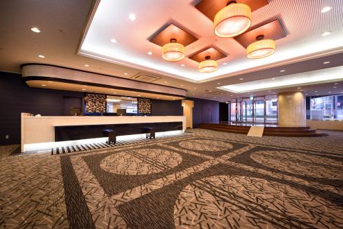 a large room with a piano and a stage at APA Hotel Utsunomiya-Ekimae in Utsunomiya