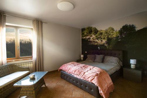 a bedroom with a bed with a painting on the wall at agriturismo villa amerina in Corchiano