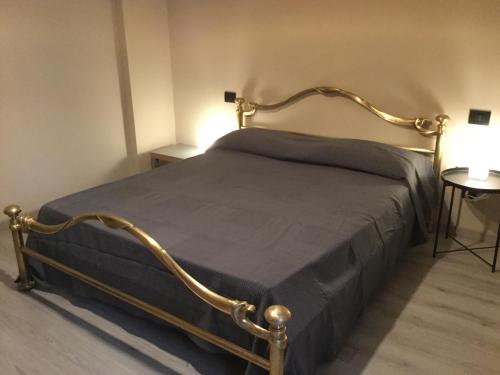 a bed with a metal frame in a room at Casa Teodora in Mantova