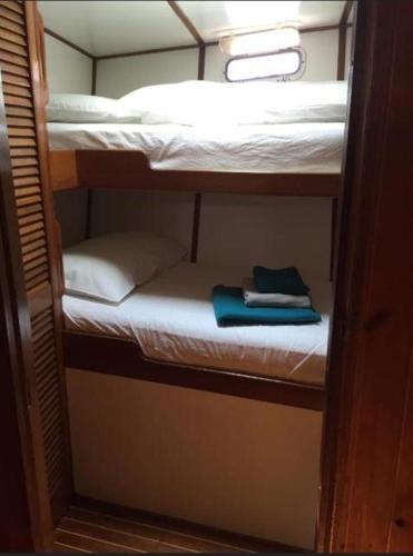 a group of bunk beds in a room at Sailing Yacht in Fiskardho