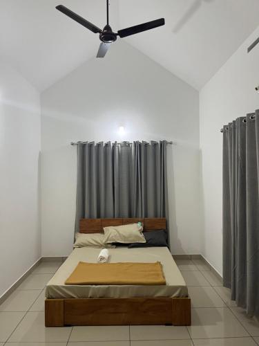 a bedroom with a bed and a ceiling fan at HOLLYWOOD Villa in Sultan Bathery