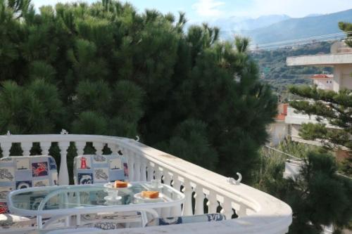 a balcony with a table and chairs on a balcony at Anestis Apartment in Akrata