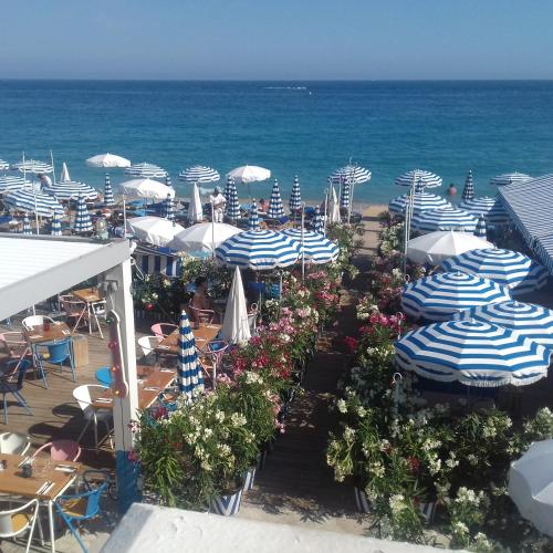 a view of a beach with umbrellas and the ocean at Chill Out Apartment, 2 mins from beach in Nice