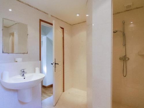 a white bathroom with a sink and a shower at Villa les Bois 10 pers in Nadalie