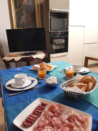 a table with a blue table cloth with food on it at La Stanza dei Sogni in Saluzzo