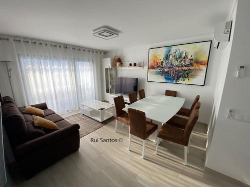 a living room with a white table and chairs at Manta Villa 2 in Manta Rota