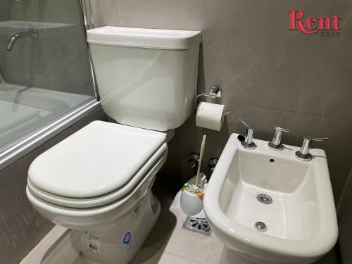 a bathroom with a toilet and a sink at Rent Muñiz in Buenos Aires