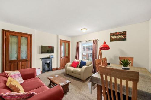 a living room with a couch and a table at Lovely 2 bedroom duplex apartment, Maidstone sleeps 5 in Maidstone