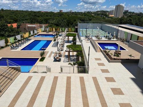 an overhead view of a building with two swimming pools at Recanto do Bosque FLAT 205 in Caldas Novas