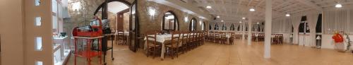a large room with tables and chairs in a building at Tenuta Chianchito in San Giovanni Rotondo