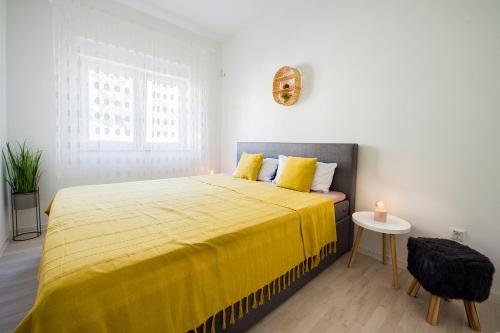 1 dormitorio con 1 cama grande con manta amarilla en Apartment dream view, en Krilo