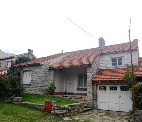 una casa de ladrillo blanco con garaje blanco en @ElChalet_PlayaGrande en insta. disfruta del mejor ambiente en el mejor barrio. Habitaciones cerrada por grupo de amigos con baño privado. en Mar del Plata