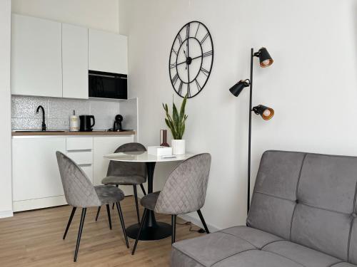 a living room with a table and chairs and a couch at Studio apartman Mia in Županja