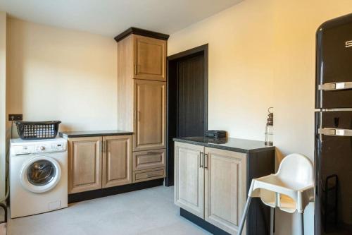 a laundry room with a washing machine and a washer at Villa Basse Cour in Durbuy