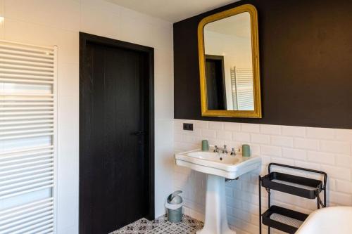 a bathroom with a sink and a mirror at Villa Basse Cour in Durbuy