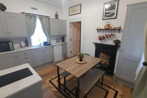 a kitchen with a table and a stove in it at The Railway Sleeper in Cullybackey