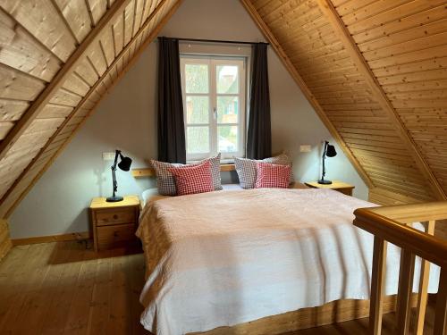a bedroom with a large bed in a attic at Ferien direkt am Wasser mit Hund in Krakow am See