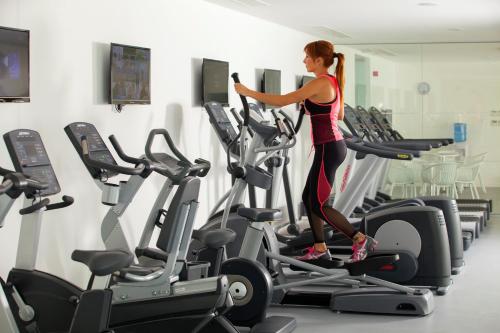 a woman on a treadmill in a gym at King Evelthon Beach Hotel & Resort in Paphos City