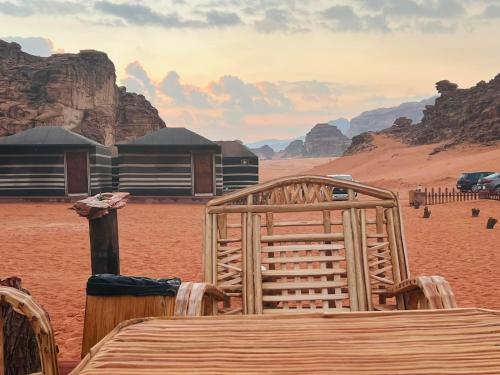 a view of a desert with a table and chairs at Maraheb Luxury camp in Wadi Rum