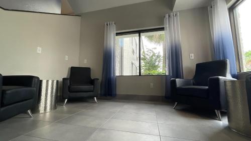 a waiting room with two chairs and a window at Destiny Palms Hotel Maingate West in Kissimmee