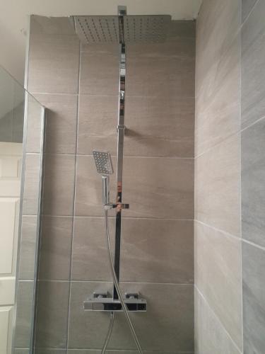 a shower with a glass door in a bathroom at South Lake House - 300m to South Lake Leisure Centre in Derrymacash