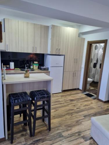 a kitchen with a counter and some stools in it at Mavrov02 Residence in Mavrovo